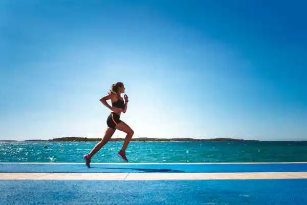 Woman running showing strong leg muscle Banbury